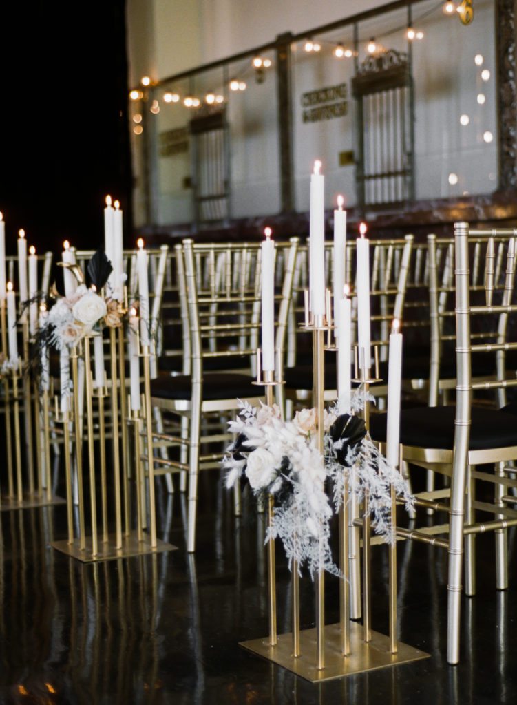 Black and white candle and floral wedding ceremony decor at St. Louis wedding venue The Noble