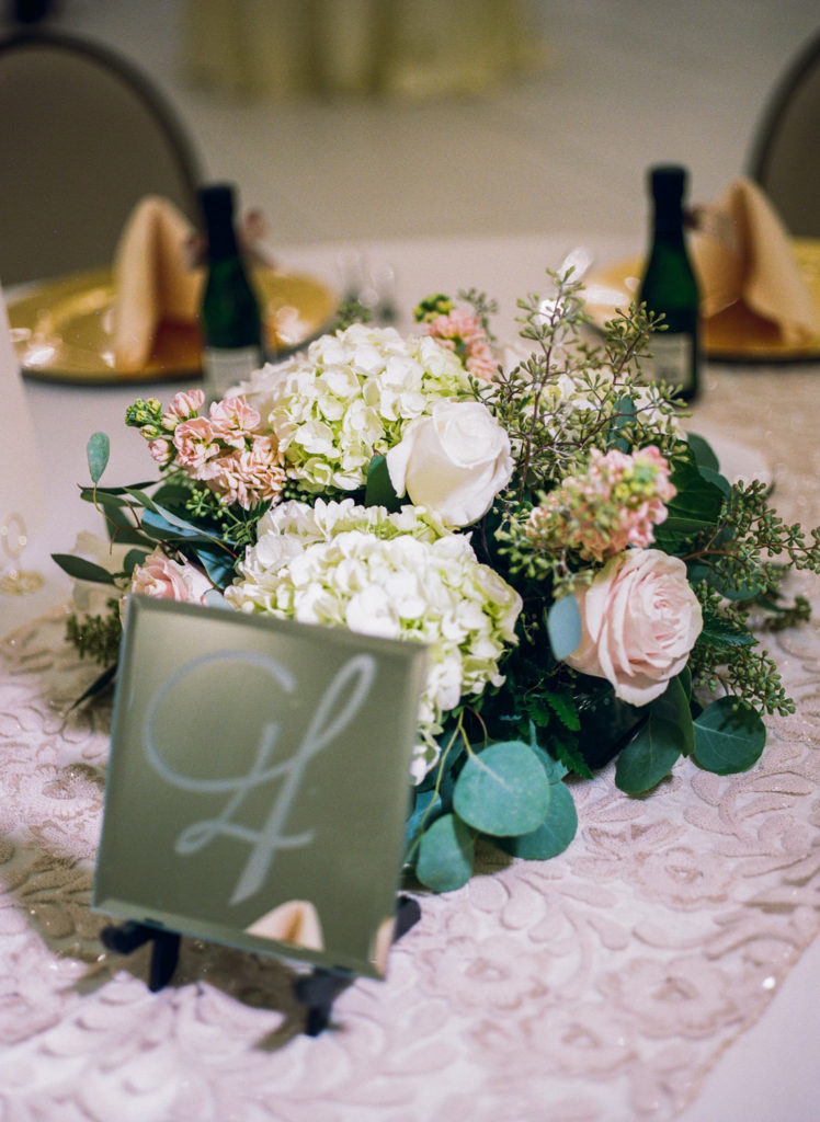 Blush and white wedding reception florals; St. Louis fine art film wedding photographer